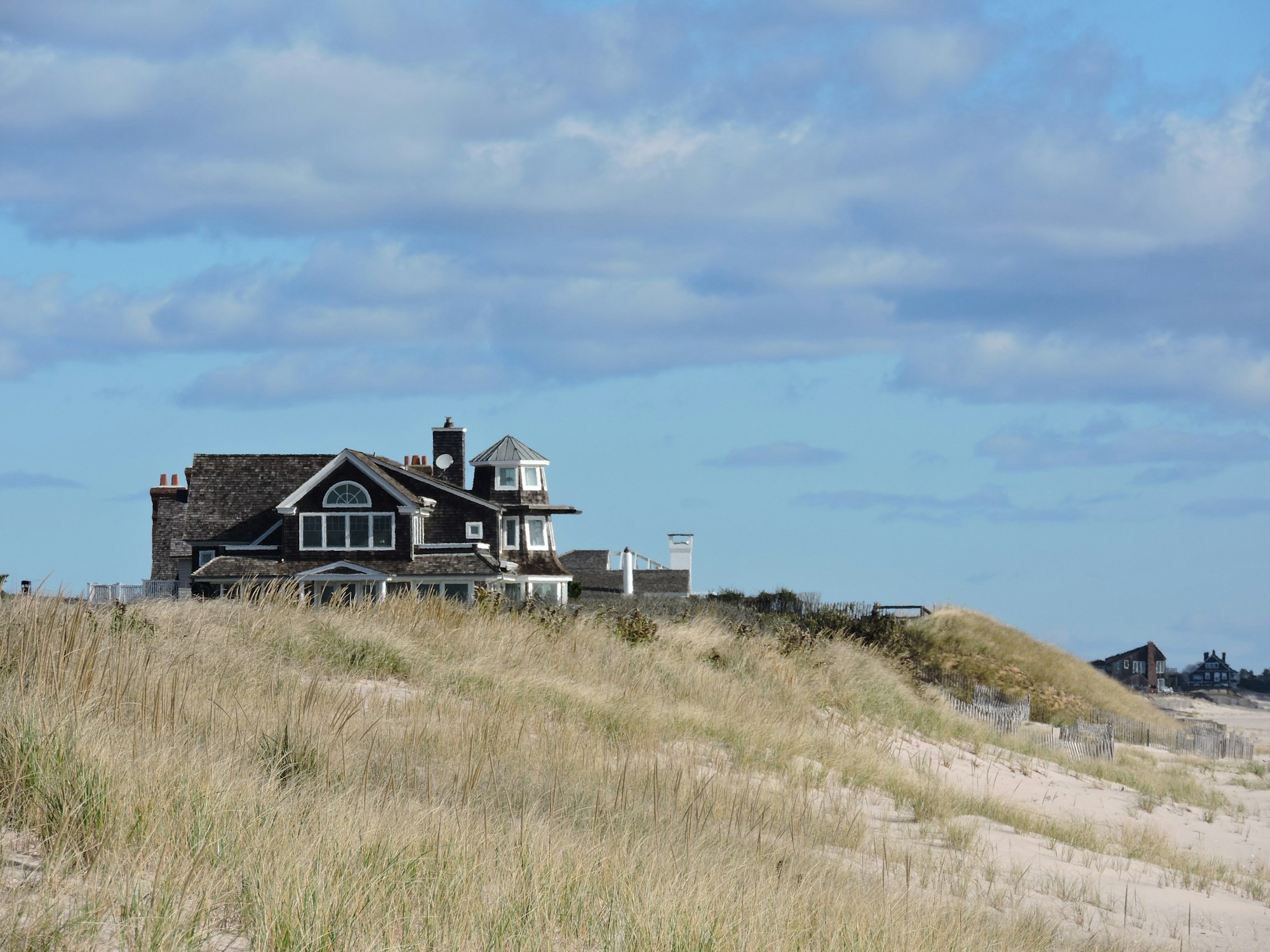 A shingled house above the dunes on the South Fork